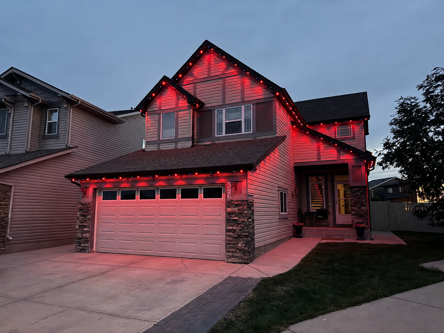 Permanent LED roofline lighting on a home exterior at night